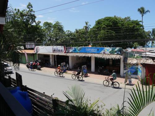 a group of people riding bikes down a street at Hotel Mandacarú Puerto Viejo in Puerto Viejo