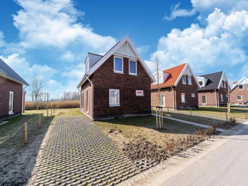 a row of houses on the side of a street at Nice holiday home with sauna near a lake in Simonshaven