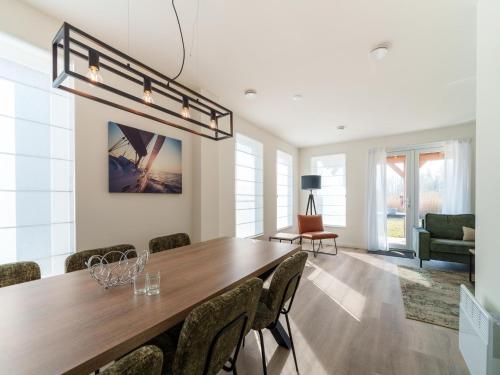 a dining room with a long table and chairs at Nice holiday home with sauna near a lake in Simonshaven