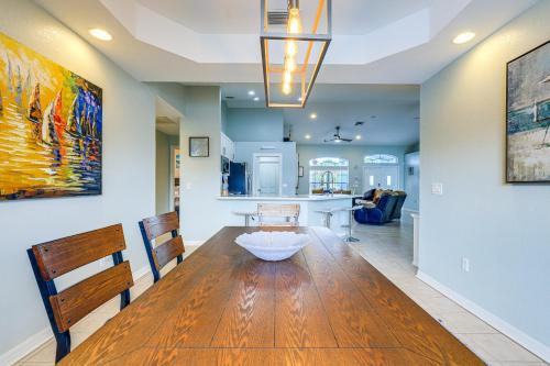 a dining room and kitchen with a table and chairs at Pet-Friendly Fort Pierce Home with Pool and Kayaks! in Fort Pierce