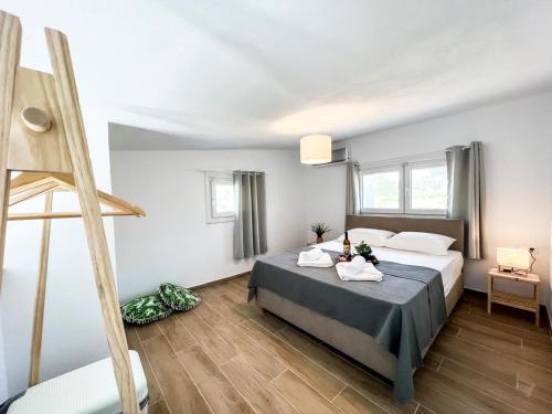 a bedroom with a bed and a ladder at LOUTRA VILLAS in Agia Paraskevi