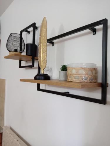 a black shelf on a wall with some items at Simic Apartmani Tara in Kaludjerske Bare