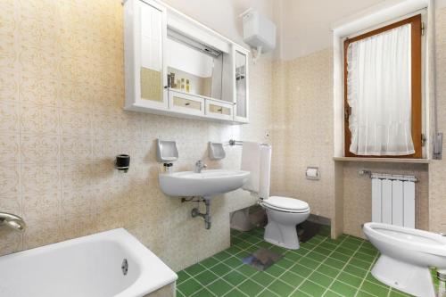 a bathroom with a sink and a toilet and a mirror at Maison Alessia - Around Sorrento in Sorrento