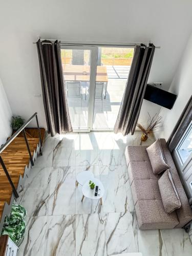 a living room with a couch and a table at LOUTRA VILLAS in Agia Paraskevi