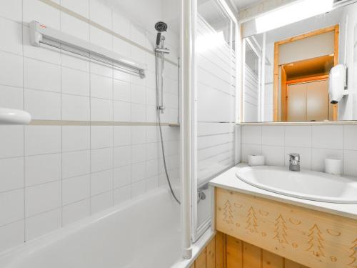 a white bathroom with a sink and a shower at Appartement rénové près des pistes avec terrasse, ski, parking et cuisine équipée - FR-1-514-48 in Courchevel