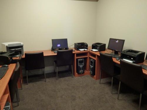 an office with two desks with two computers on them at Atlantis Hotel Melbourne in Melbourne