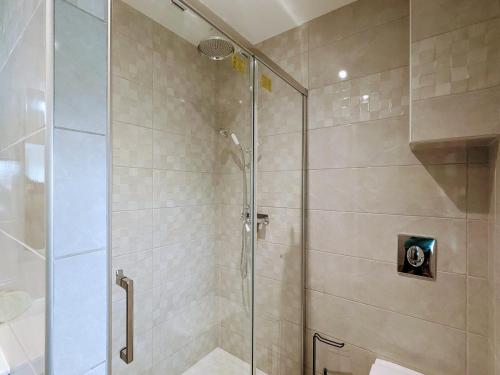 a shower with a glass door in a bathroom at Gîte familial rénové avec piscine, jardin de 1 hectare et vélos à disposition, situé en pleine campagne - FR-1-591-579 in Tilly