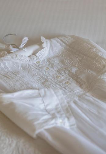 a close up of a white dress on a bed at Shelbourne Georgian Townhouse in Kenmare