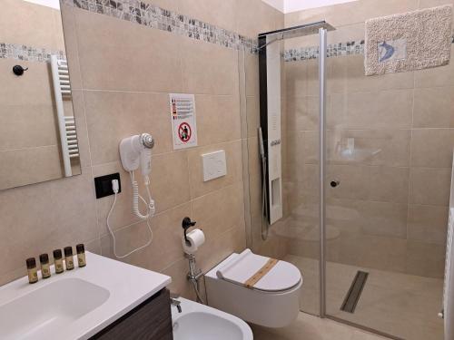 a bathroom with a shower and a toilet and a sink at Palazzo Castellano in Lecce