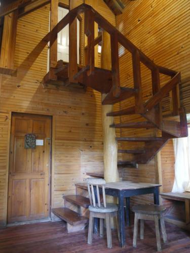 a wooden room with a wooden staircase in a cabin at Hotel Mandacarú Puerto Viejo in Puerto Viejo
