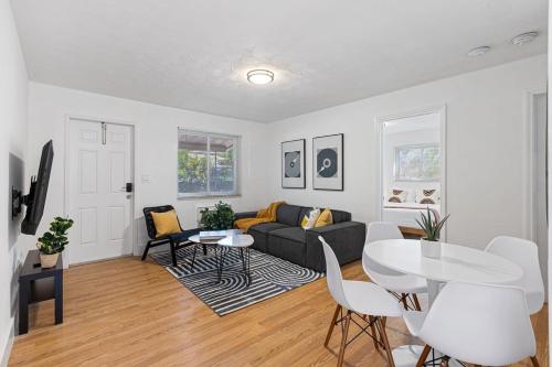 a living room with a couch and a table at Lake Ridge Villa - Free Parking in Fort Lauderdale