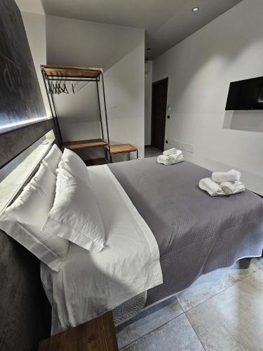 a bedroom with a bed with two towels on it at Binario1 Rooms in Barletta