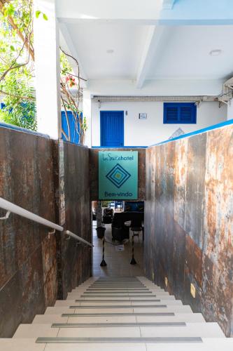 an entrance to an office with a sign on the wall at La Suite Praia Hotel in Caucaia