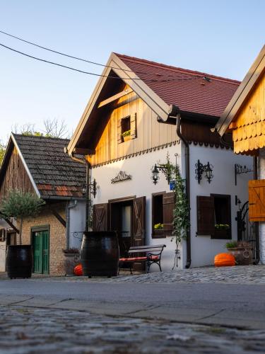 a building with a bench in front of it at Studio apartman & Wine House ONDINE in Zmajevac