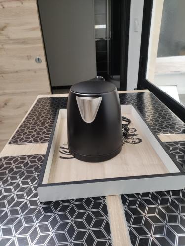 a black appliance sitting on top of a kitchen counter at Bienvenue chez Coco in Dunkerque
