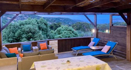 a patio with chairs and tables and a view at Appartement Cemiliana in Bonifacio