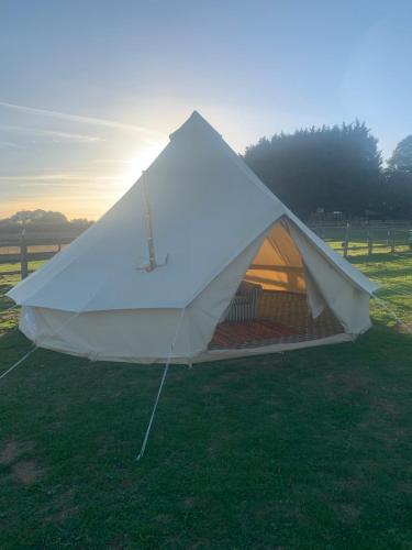 a white tent in the grass in a field at Bell Tent in Horspath