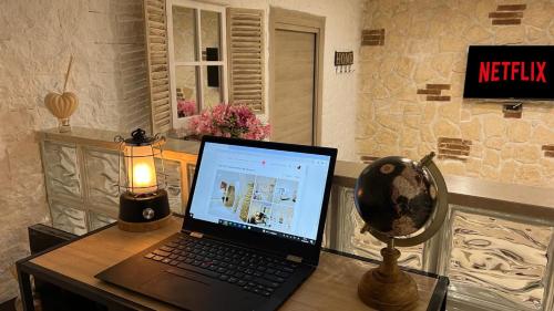 a laptop computer sitting on a desk with a lamp at Appartamento Suarez Vomero in Naples
