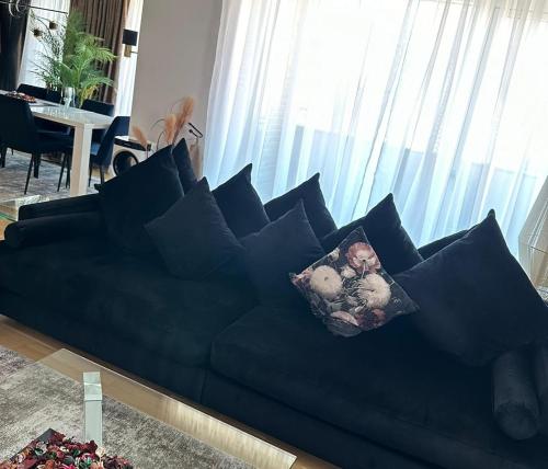 a blue couch with pillows in a living room at Attraktiv lejlighed in Odense