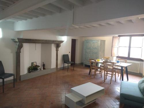 a living room with a table and chairs at Palazzo Reali Apartment - Camera nella storia di Pistoia in Pistoia