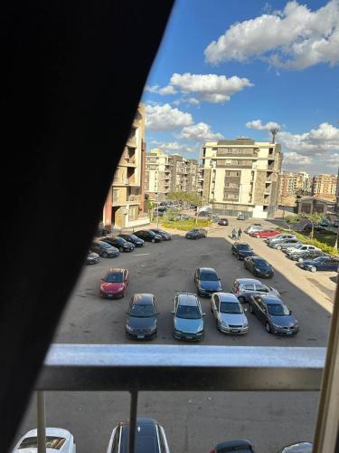 a view of a parking lot with cars parked at Cozy apartment New Cairo in New cairo