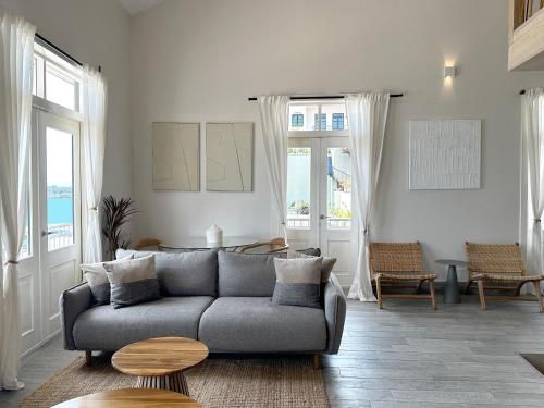 a living room with a couch and a table at AmazINN Places Casa del Mar in Panama City