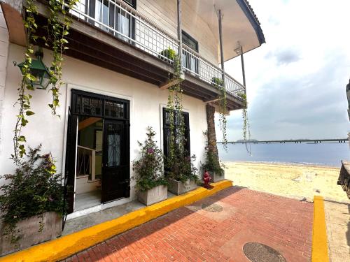 a building on the beach with a fire hydrant in front of it at AmazINN Places Casa del Mar in Panama City