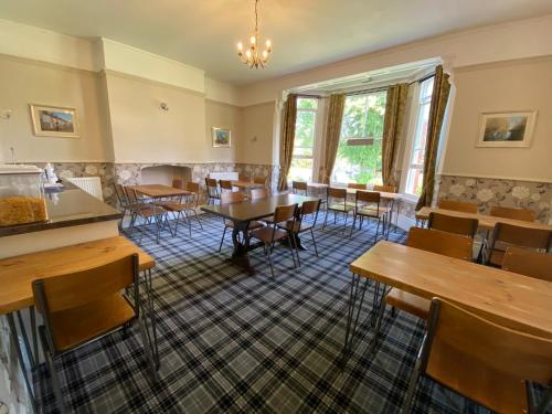 a dining room with tables and chairs at Fairlawns Guest House in Banbury