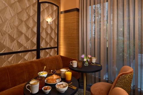 a restaurant with a table with food on it at Maison Cassandre in Paris