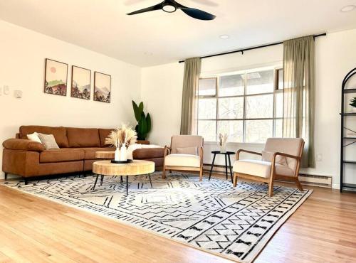 a living room with a couch and chairs and a table at Veda Vista - Newly renovated - Rustic Modern Home in Harpers Ferry