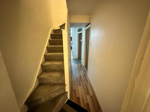 a staircase in a house with a stair case at Bethnal Green Rooms R4 in London