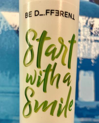 a drink cup with a sign that reads start with a smile at Villa Hotel Frankfurt by MZ HotelCollection in Frankfurt