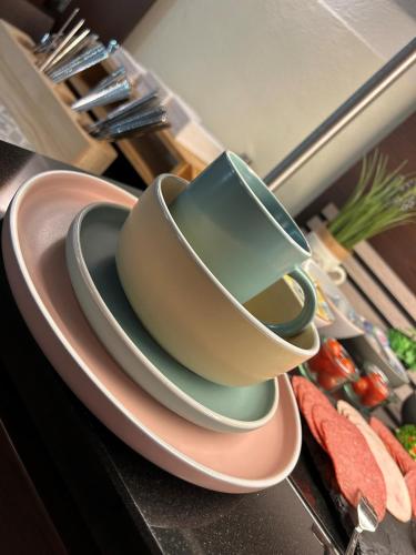 a stack of bowls on a plate on a kitchen counter at Villa Hotel Frankfurt by MZ HotelCollection in Frankfurt