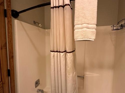 a bathroom with a shower with a shower curtain at Lifts West G8 in Red River