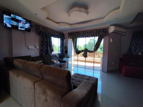 a living room with a couch and a large window at Ñande renda in Ciudad del Este