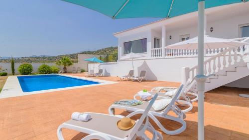 a villa with a swimming pool and a house at Villa María de Periana by Ruralidays in Periana