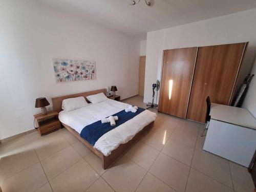 a bedroom with a bed with two teddy bears on it at St Julians Sliema 3 minutes walk from promenade 3 bedroom apartment in Sliema
