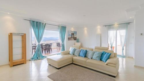 a living room with a white couch and blue pillows at Villa María de Periana by Ruralidays in Periana