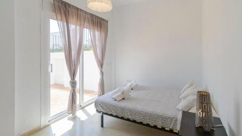 a bedroom with a bed and a large window at Villa María de Periana by Ruralidays in Periana