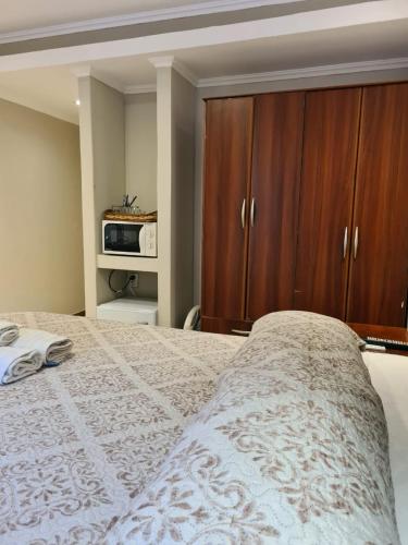 a bedroom with a bed with a wooden cabinet at Hotel Firenze in Necochea