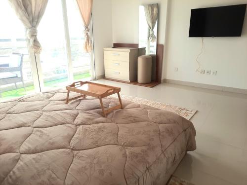 a bedroom with a bed with a wooden table on it at Chambres meublées Avenue Cheikh Anta Diop in Dakar