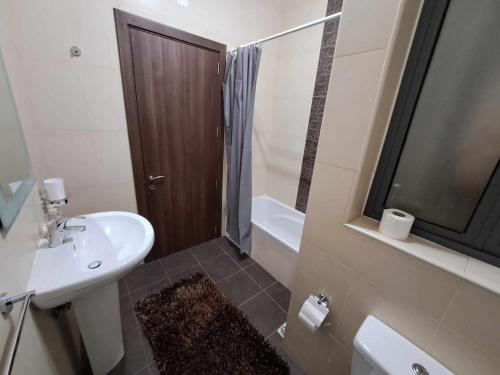 a bathroom with a sink and a toilet and a shower at St Julians Sliema 3 minutes walk from promenade 3 bedroom apartment in Sliema