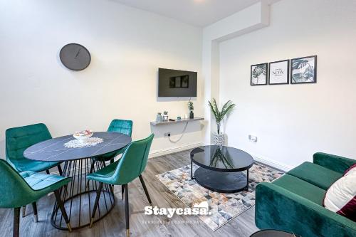 a living room with a table and chairs and a couch at Ashfield Co-Living - Private Room Self-Cater in Manchester