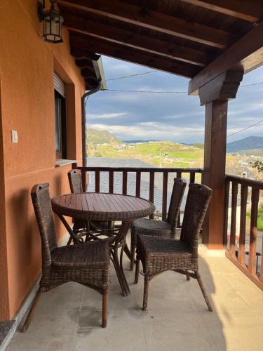 a table and chairs on a balcony with a view at Casa Miraval in Oval