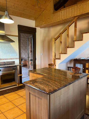 a kitchen with a counter top and a staircase at Casa Miraval in Oval