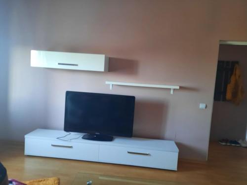 a tv sitting on a white cabinet in a room at Apartament in Năvodari