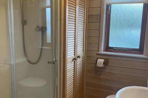 a bathroom with a shower and a sink at Campsie Glen Holiday Park in Glasgow