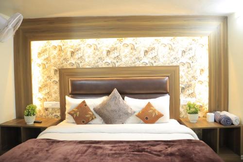 a bedroom with a large bed with pillows at Seth Residency near Golden Temple in Amritsar
