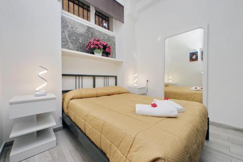 a small bedroom with a bed and a mirror at Domus Monamì Apartment in Rome
