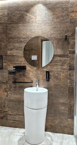a bathroom with a white toilet and a mirror at Binario1 Rooms in Barletta
